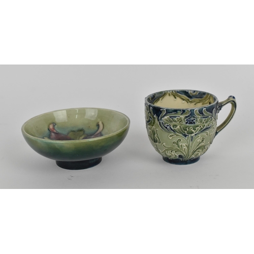 101 - A William Moorcroft Florian ware cup, with tube lined foliate design in green and blue tones, with W... 