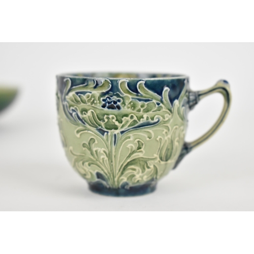 101 - A William Moorcroft Florian ware cup, with tube lined foliate design in green and blue tones, with W... 