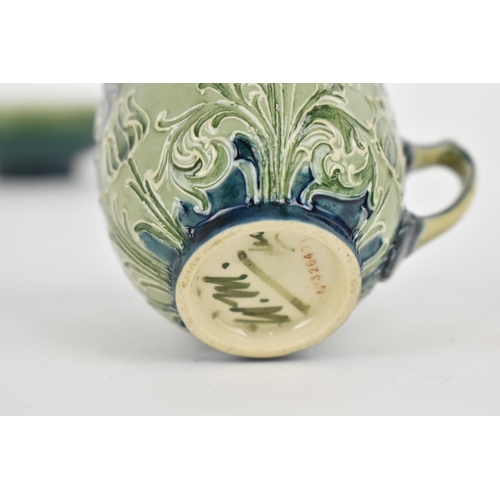 101 - A William Moorcroft Florian ware cup, with tube lined foliate design in green and blue tones, with W... 