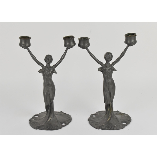 104 - A pair of Art Nouveau pewter figural candelabra, in the WMF style, each modelled as a nymph in flowi... 