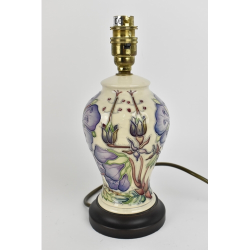 109 - A Moorcroft pottery 'Meadow Cranesbill' pattern lamp designed by Phillip Gibson, the baluster body d... 