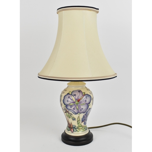 109 - A Moorcroft pottery 'Meadow Cranesbill' pattern lamp designed by Phillip Gibson, the baluster body d... 