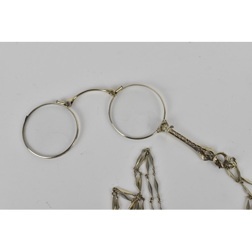 158 - A pair of late Victorian white metal lorgnette, with button system, on a faceted link chain, the cha... 