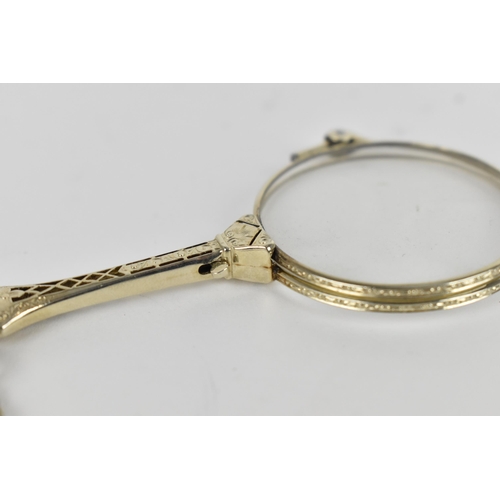 158 - A pair of late Victorian white metal lorgnette, with button system, on a faceted link chain, the cha... 