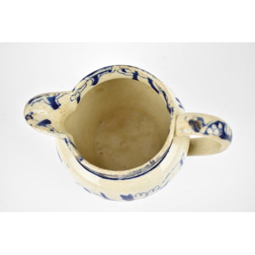 170 - A 19th century blue and white pearlware jug, in the Chinese taste, the rim with floral frieze above ... 