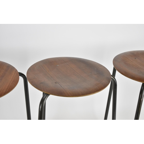 78 - A set of four Arne Jacobsen for Fritz Hansen style 'Dot' stools, with circular seat rests on tripod ... 