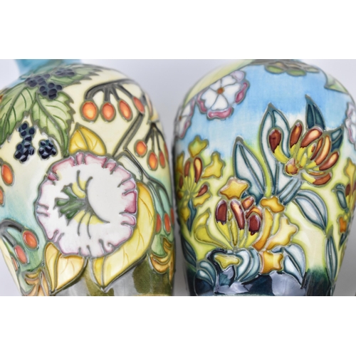 83 - A cased set of Moorcroft pottery small posy vases, in various floral patterns, dated 2000, possibly ... 