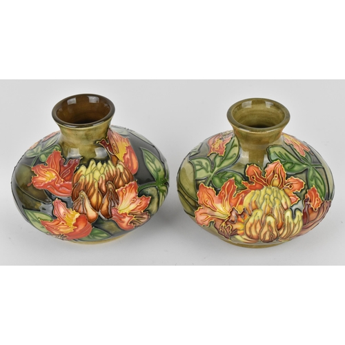 87 - A pair of Moorcroft pottery vases designed by Philip Gibson, in the 'Flame of the Forest' pattern, o... 