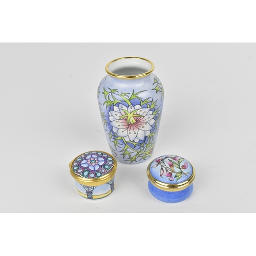 89 - A set of three Moorcroft enamels miniatures, to include a vase and two pill boxes, each in fitted bo... 