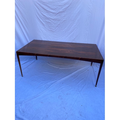 97 - A Heals rosewood dining table, of rectangular form with tapered legs ending in brass disc feet, toge... 