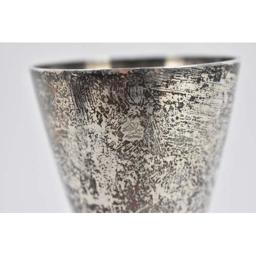 111 - A 1970s silver champagne flute by Stuart Devlin, the conical bowl above a textured stem with spreadi... 