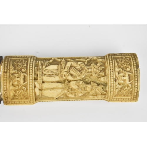 174 - A late 19th century oriental jambiya, the carved bone handle with figures between floral friezes wit... 