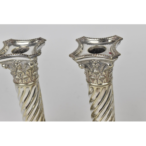 178 - A set of four George III style silver plated candlesticks by Joseph Rodgers & Sons, the twist fluted... 