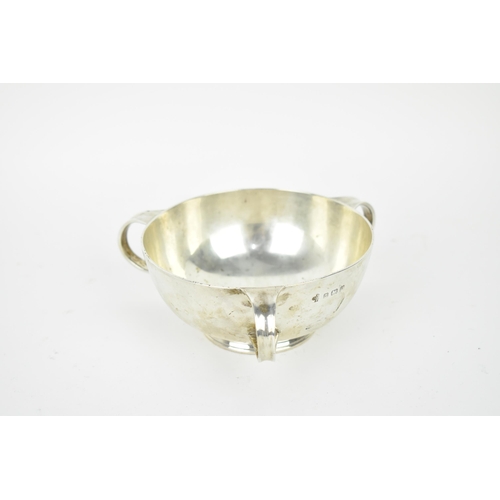 193 - An Arts and Crafts style three handled silver bowl by William Hutton & Sons, Birmingham 1919, of cir... 