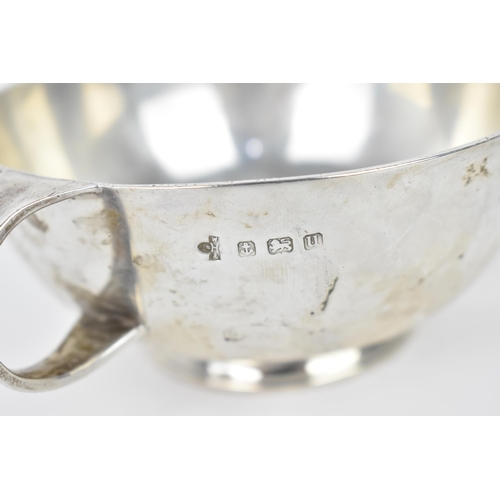 193 - An Arts and Crafts style three handled silver bowl by William Hutton & Sons, Birmingham 1919, of cir... 