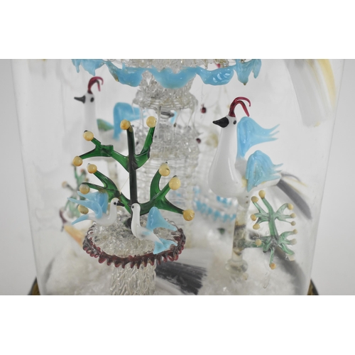 194 - A Victorian lampwork sculpture under a glass dome, modelled as various exotic birds drinking from a ... 