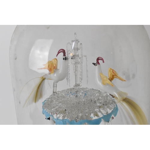 194 - A Victorian lampwork sculpture under a glass dome, modelled as various exotic birds drinking from a ... 