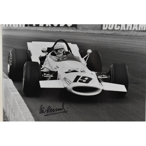 199 - A signed reprinted photograph of Vic Elgood, racing in a McLaren at the British Grand Prix at Silver... 