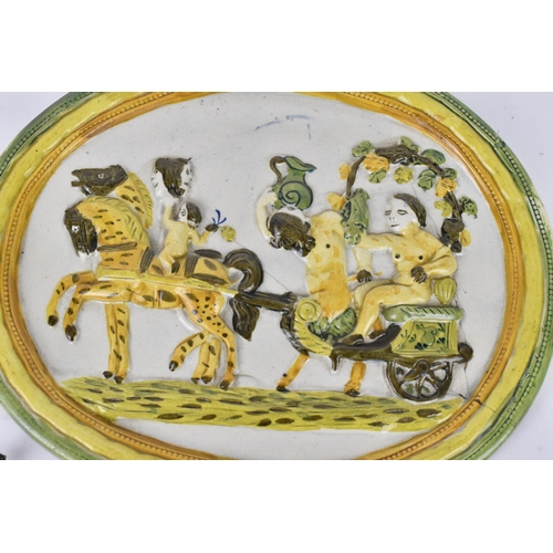 207 - A small group of early 19th century prattware plaques, to include a bacchanalian scene with a satyr ... 