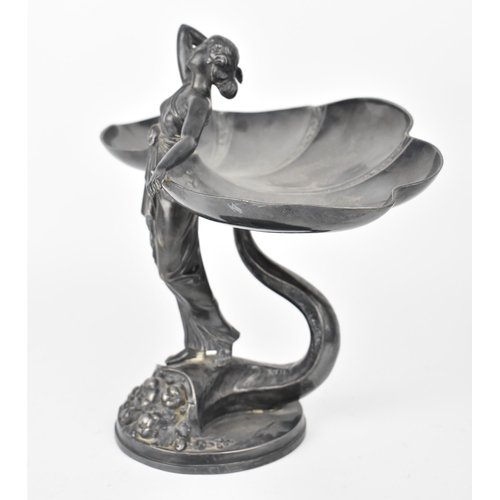 72 - An Art Nouveau WMF silver plated card tray modelled as a maiden in draped clothing with standing on ... 