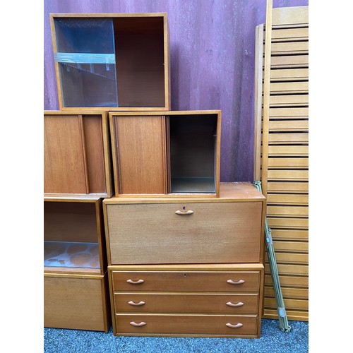 38 - A mid 20th century Ladderax style modular unit consisting of a three drawer chest, two fall down cup... 