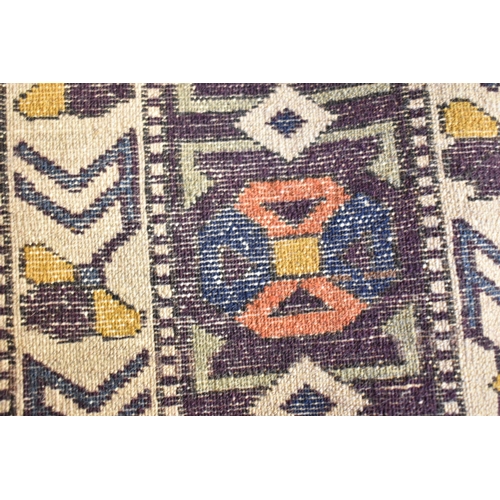 246 - A Kazak rug with three medallions on an off white ground in red, blue, yellow, orange and brown, 153... 