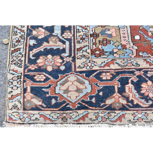 153 - A Tabriz carpet with a central medallion, geometric palmets, flowers, vines and spandrels in pastel ... 