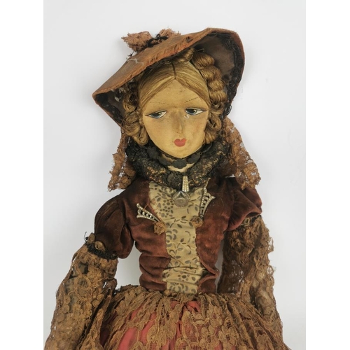 231 - An early 20th century doll with painted fabric face, a flat back head and a hanging ring, compositio... 