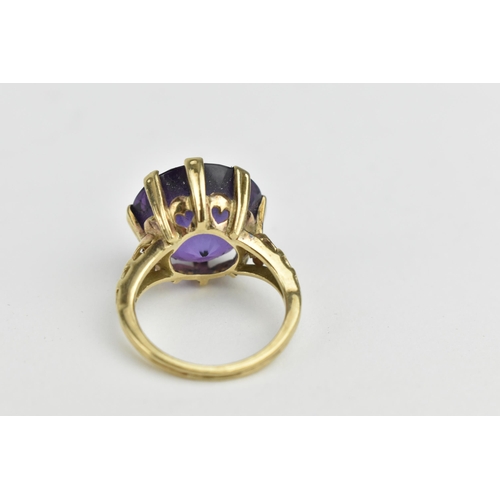 236 - A gold coloured ring and a gold plated ring set with seed pearls, each set with a purple stone