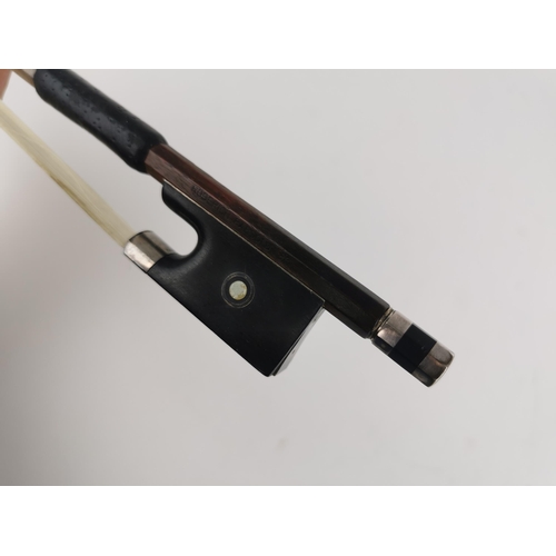 243 - A German violin bow by Roderich Paesold with silver wire binding, mother of pearl inlay, ebony frog ... 