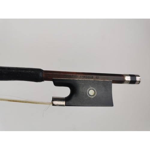 243 - A German violin bow by Roderich Paesold with silver wire binding, mother of pearl inlay, ebony frog ... 