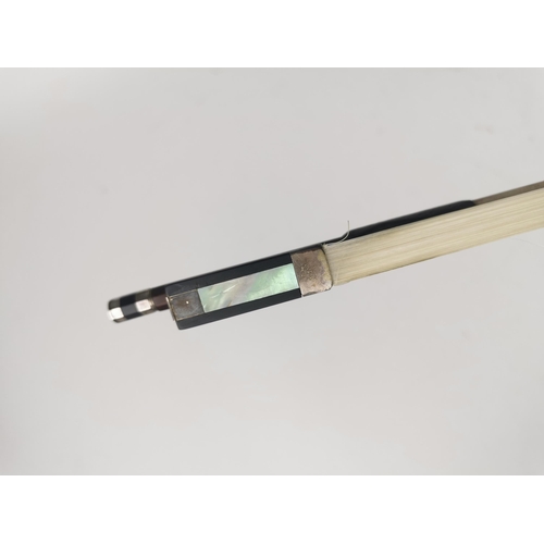 243 - A German violin bow by Roderich Paesold with silver wire binding, mother of pearl inlay, ebony frog ... 