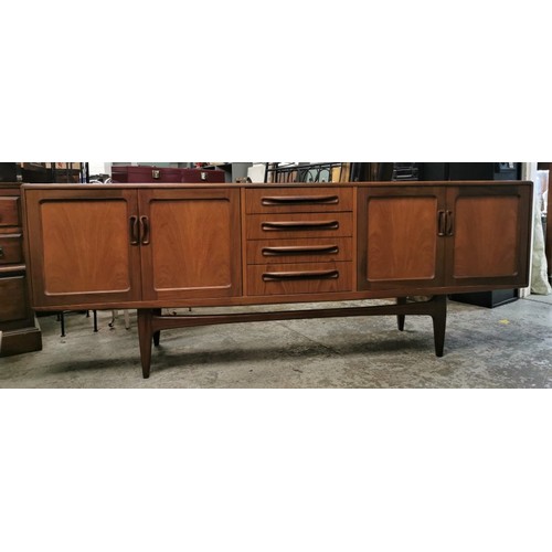 242 - A 1970s G-Plan E Gomme teak Fresco sideboard with twin cupboard doors either side flanking a central... 