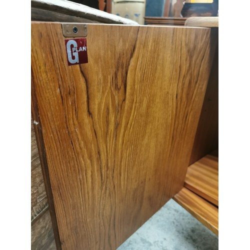 242 - A 1970s G-Plan E Gomme teak Fresco sideboard with twin cupboard doors either side flanking a central... 