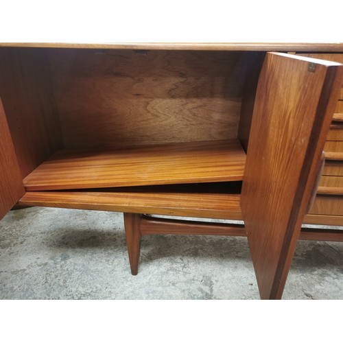 242 - A 1970s G-Plan E Gomme teak Fresco sideboard with twin cupboard doors either side flanking a central... 