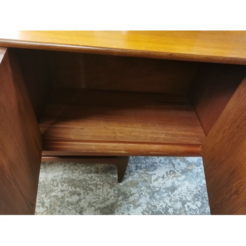 242 - A 1970s G-Plan E Gomme teak Fresco sideboard with twin cupboard doors either side flanking a central... 