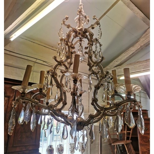 245 - A Louis XV style eight light cage chandelier, with cut crystal pear shaped pendalogues, faceted drop... 