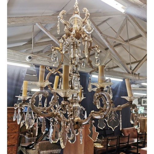 245 - A Louis XV style eight light cage chandelier, with cut crystal pear shaped pendalogues, faceted drop... 