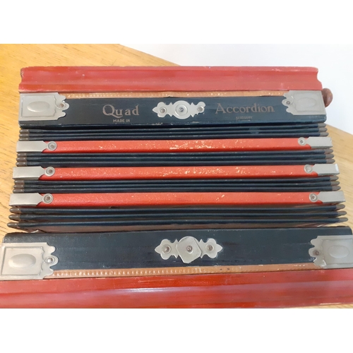 118 - A vintage Quad accordion in red and black, 20cm x 28cm. Location:1:1
Condition: Handle A/F and some ... 