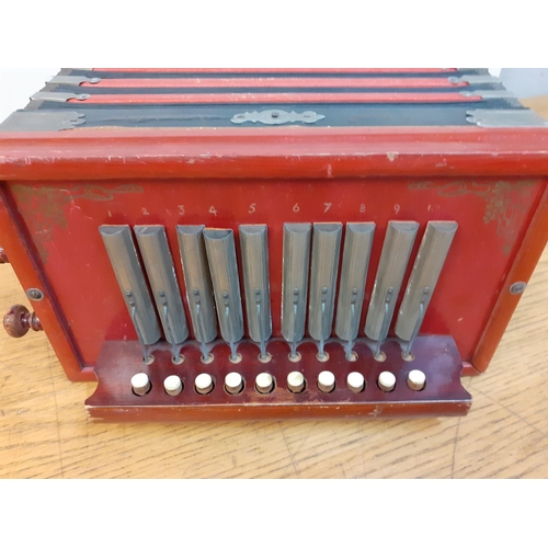 118 - A vintage Quad accordion in red and black, 20cm x 28cm. Location:1:1
Condition: Handle A/F and some ... 