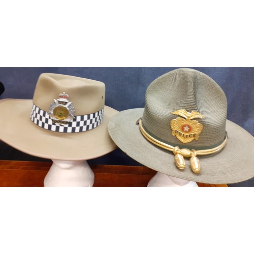 66 - Four Worldwide police hats comprising a Tasmanian police fur felt hat made by Mountcastle PTY, size ... 