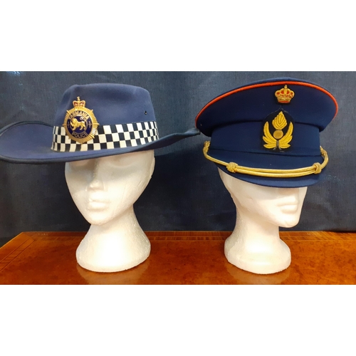 66 - Four Worldwide police hats comprising a Tasmanian police fur felt hat made by Mountcastle PTY, size ... 