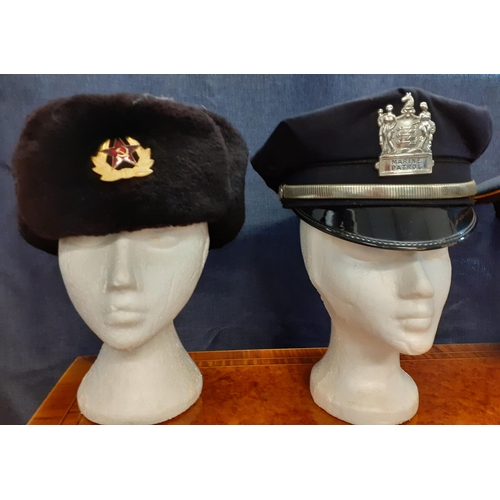 68 - Four Worldwide police, army and marine patrol hats comprising a Russian army Genka Winter hat, size ... 