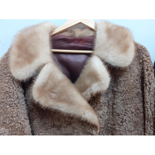 71 - Two vintage coats comprising a Scandinavian Fur Company brown beaver lamb coat with brown musquash f... 