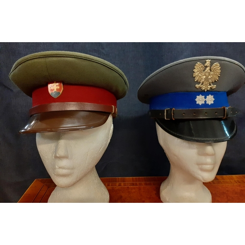 76 - Four Worldwide police hats comprising a Polish cap, size 54, a Slovak Republic cap made by Kras Brun... 