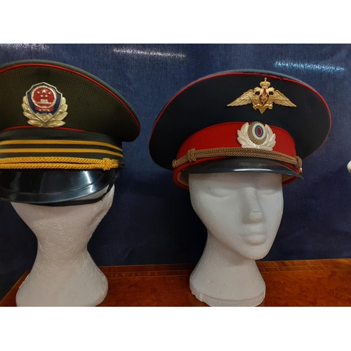 78 - Four Worldwide police hats comprising an Indonesian National police cap (POLRI), a Danish police con... 