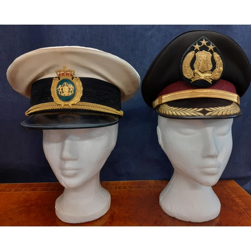 78 - Four Worldwide police hats comprising an Indonesian National police cap (POLRI), a Danish police con... 