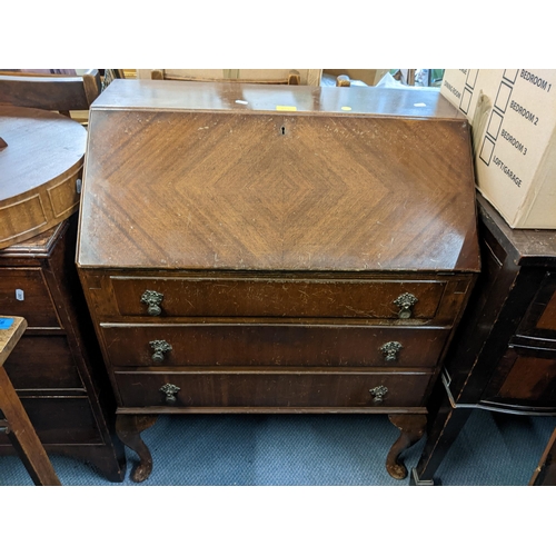 154 - A mid 20th century mahogany bureau together with a walnut sewing cabinet, drum table and an occasion... 