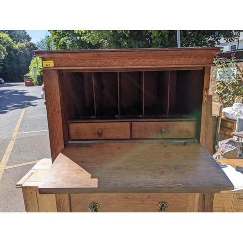 221 - An early 20th century oak Wellington chest having a fall flap opening to reveal a fitted interior an... 