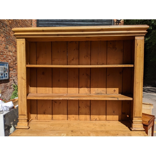 226 - A large Victorian pine dresser having a plate rack above two drawers and cupboards below, 218.5cm h ... 